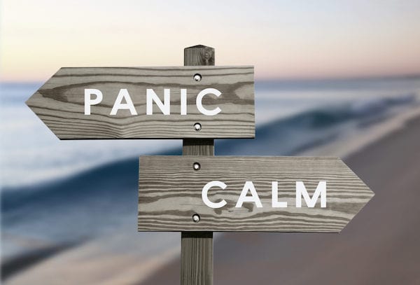 signpost with one sign reading panic and one sign, pointing in the opposite direction, reading calm