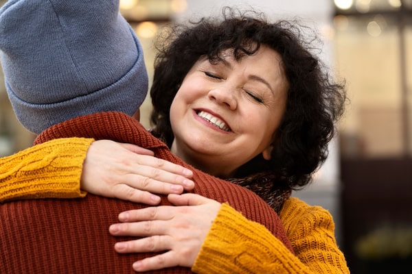 woman hugging someone and smiling