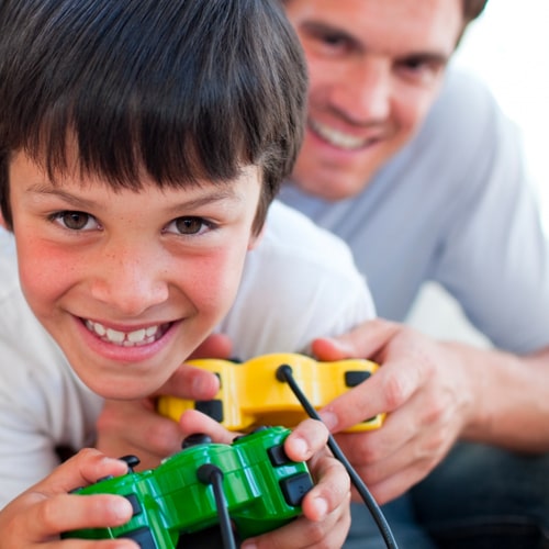 young boy and father holding video game controllers