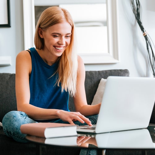 woman on video call smiling at laptop