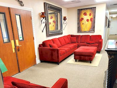 roseville office with comfortable red sofa