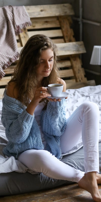woman sitting on floor drinking tea