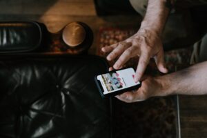 Person Using a Smartphone with Dating-Matching App on Screen
