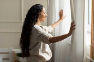 happy woman looking through window