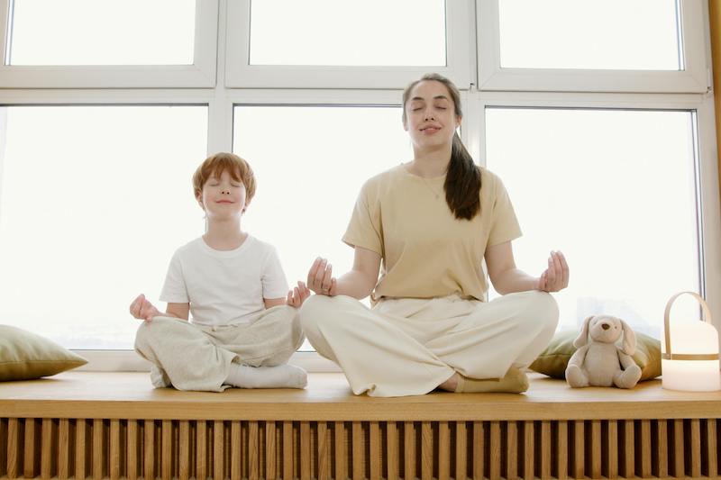 mother and son meditating together