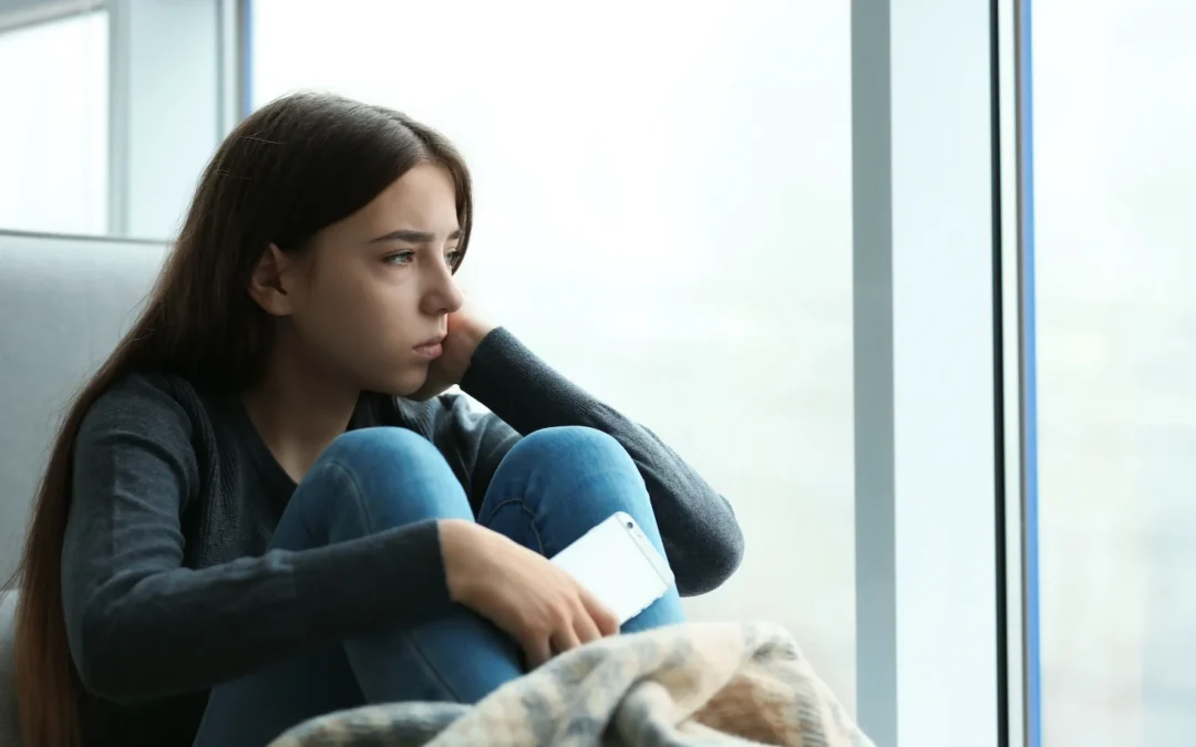 anxious teen looking out the window