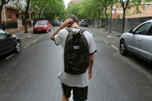 teen scratching head
